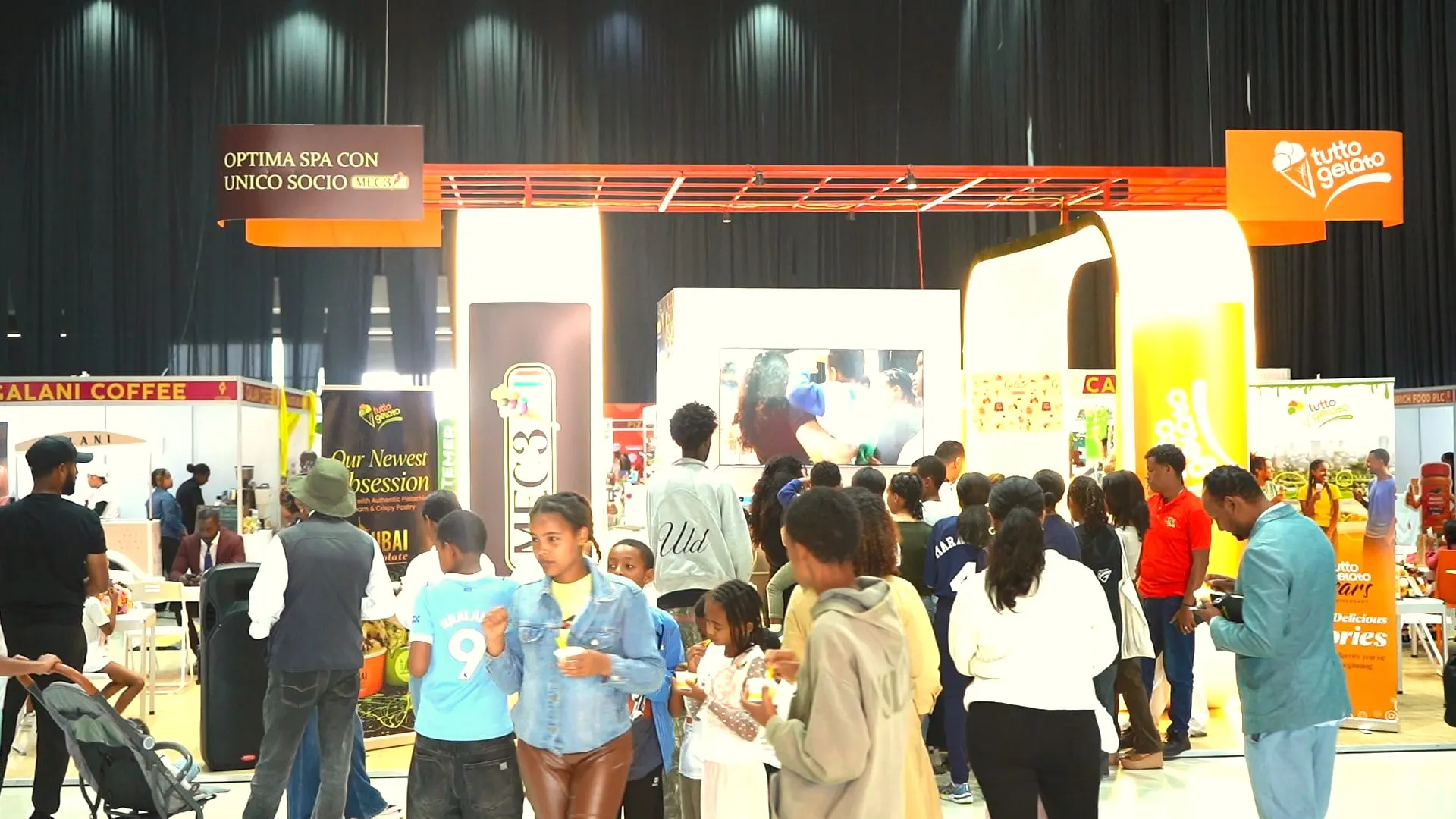 Crowds moving between gelato booths