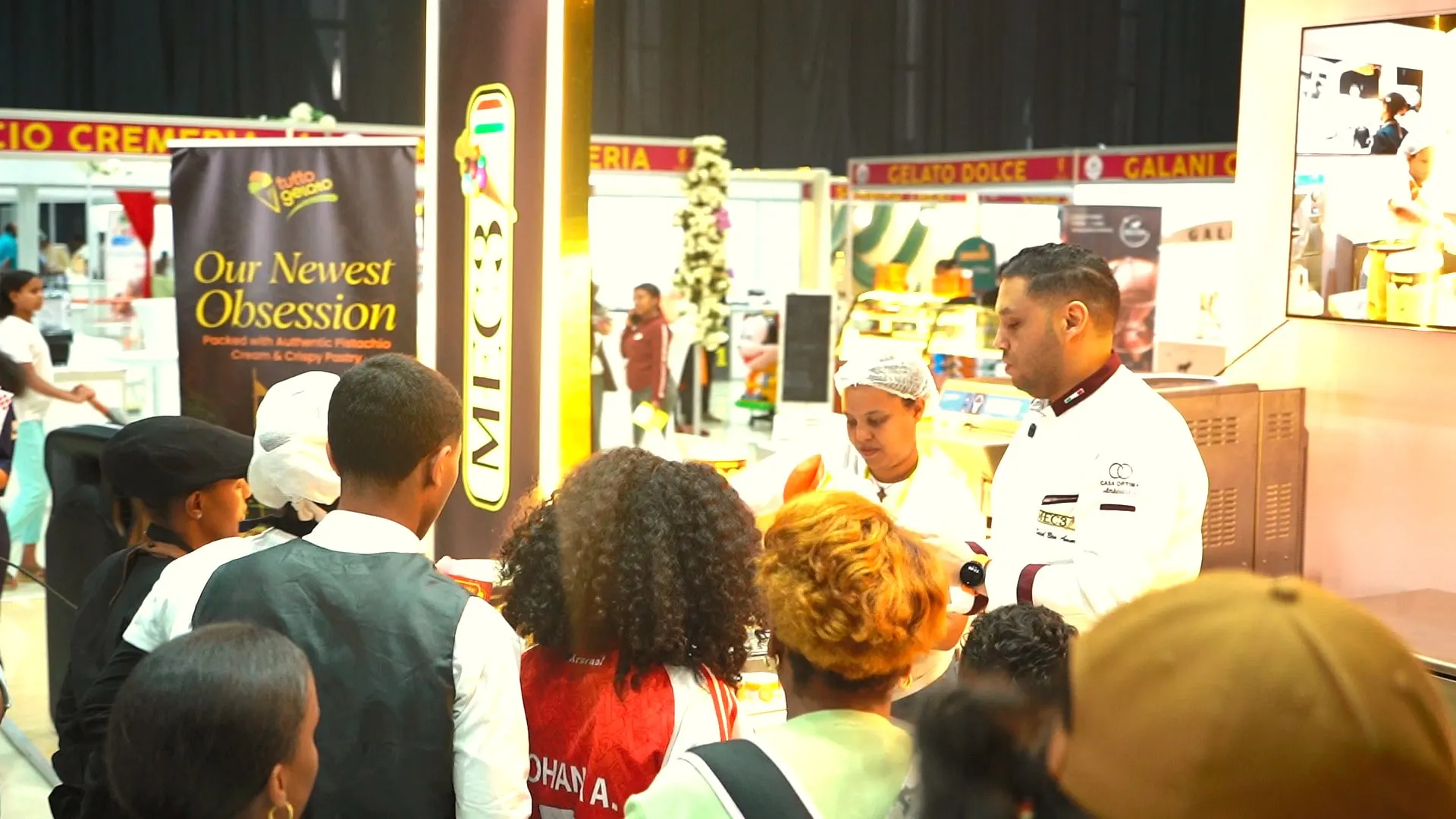 Chef serving gelato to a crowd of visitors