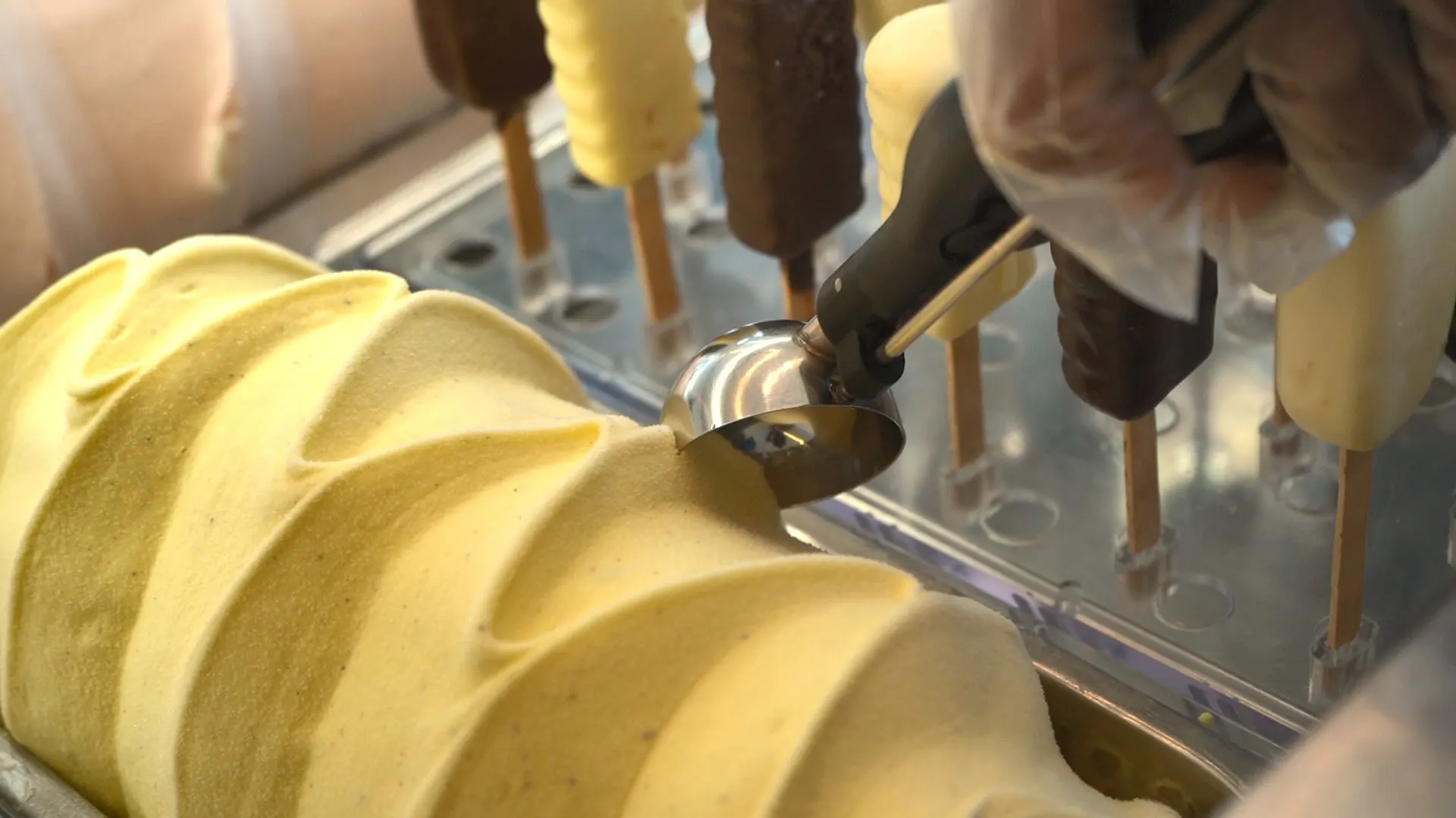 A scoop of pistachio gelato being served
