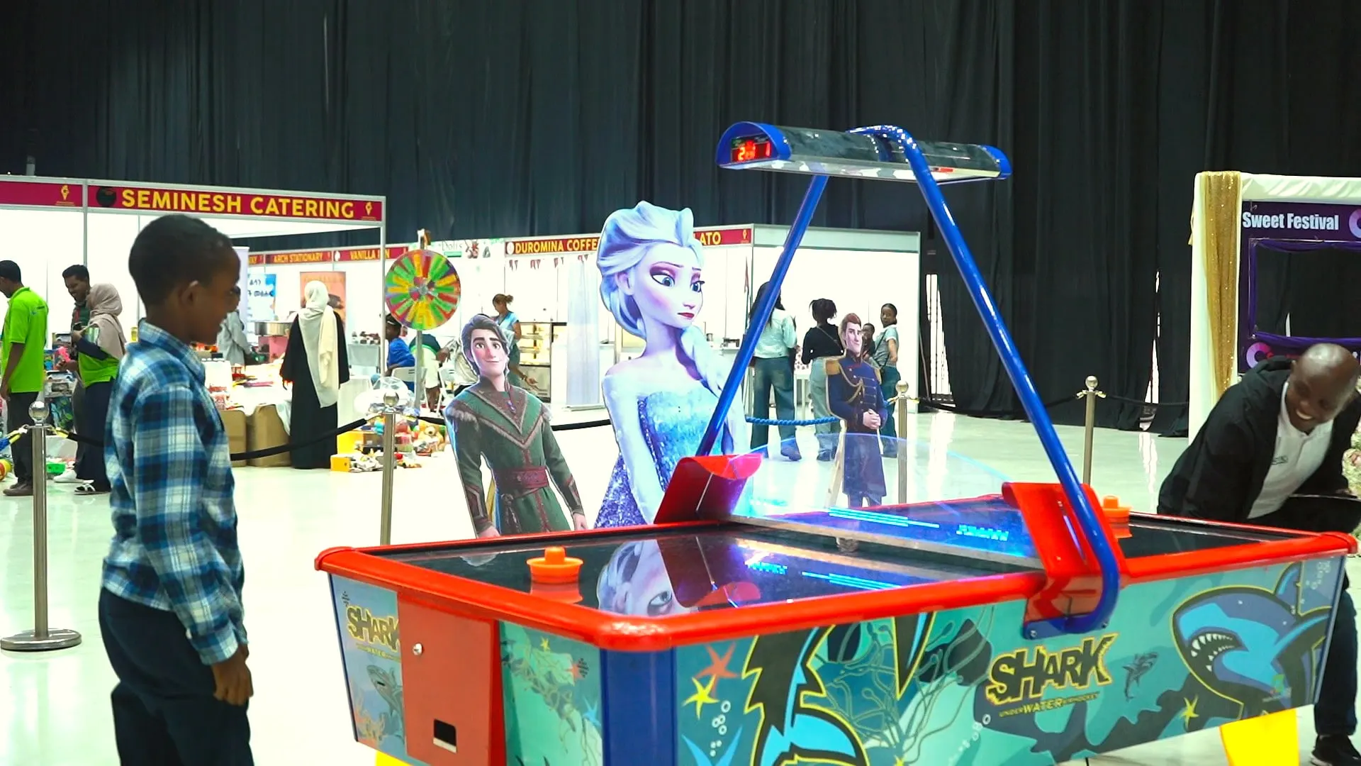 Children playing air hockey in the family zone